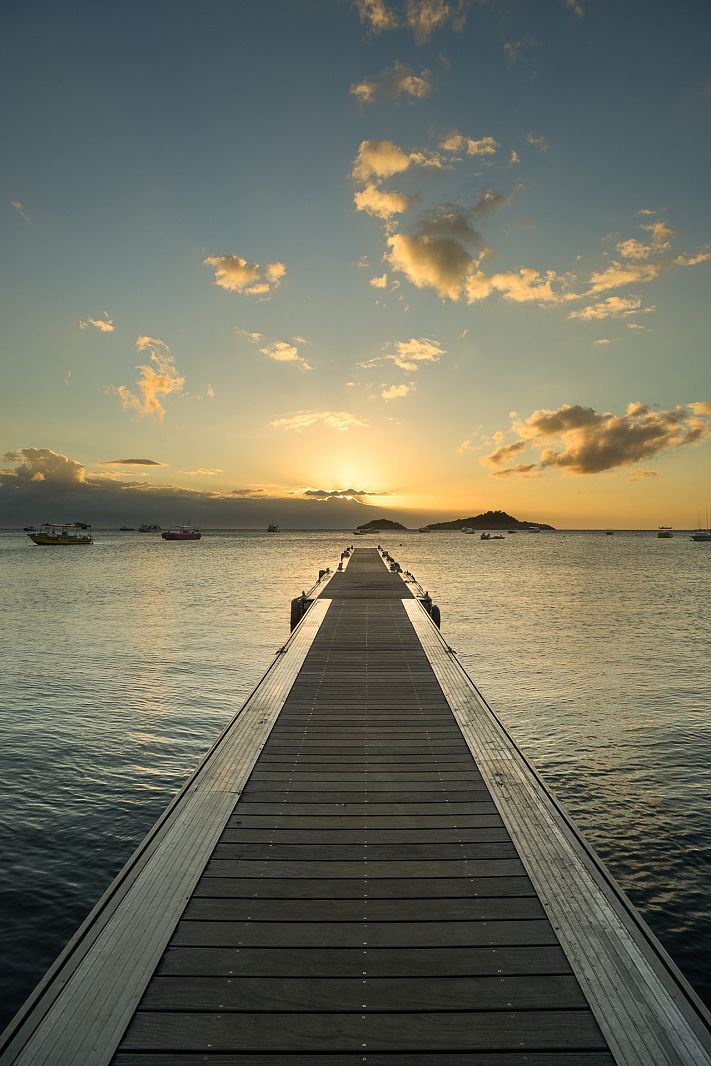 The pier at Plage de Malendure with Ilet Pigeon in the background, Guadeloupe.