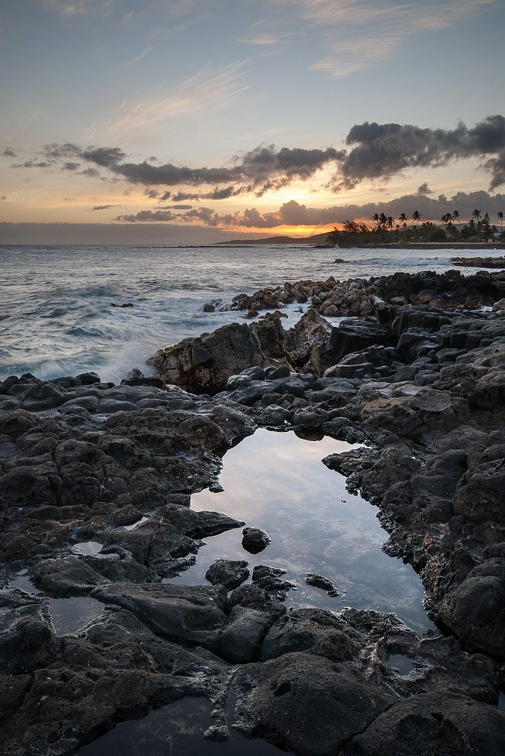 Sunset over lava rocks, Poipu, Hawaii, USA
